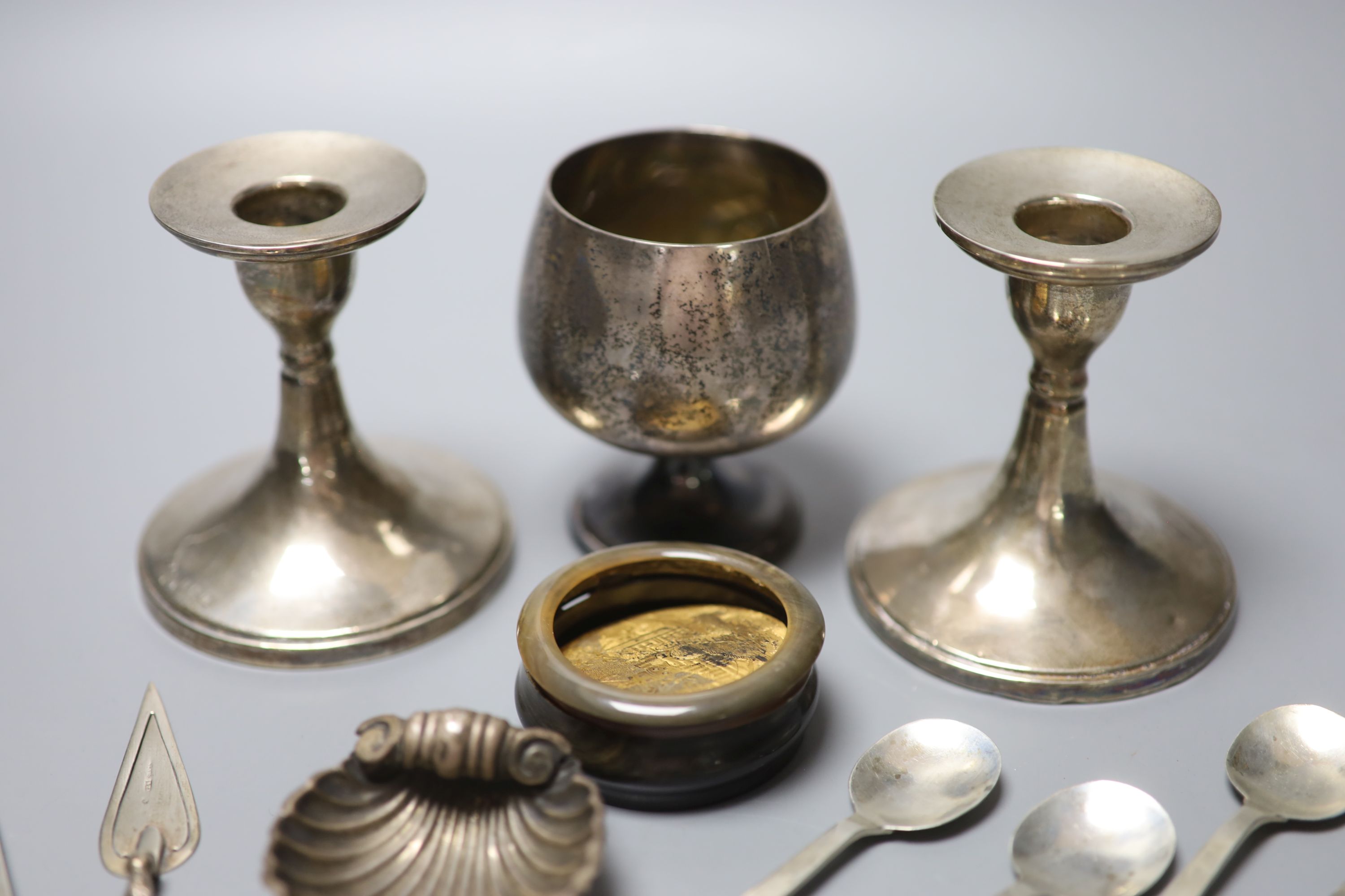 A group of small silver including dwarf candlesticks, coffee spoons, vesta, goblet, bookmark etc. and a horn box.